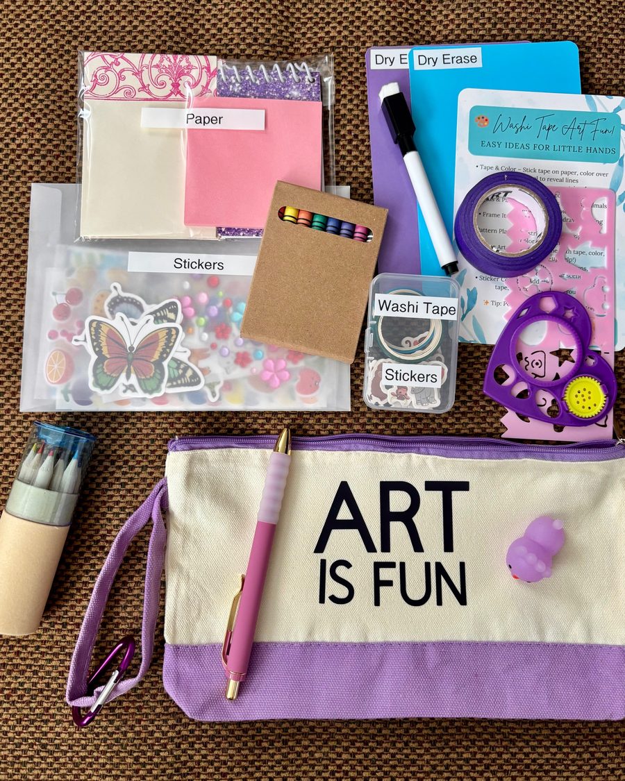 Purple Art Is Fun pouch laid out with its contents: butterfly stickers, paper, crayons, colored pencils, purple washi tape, dry-erase boards and a stencil