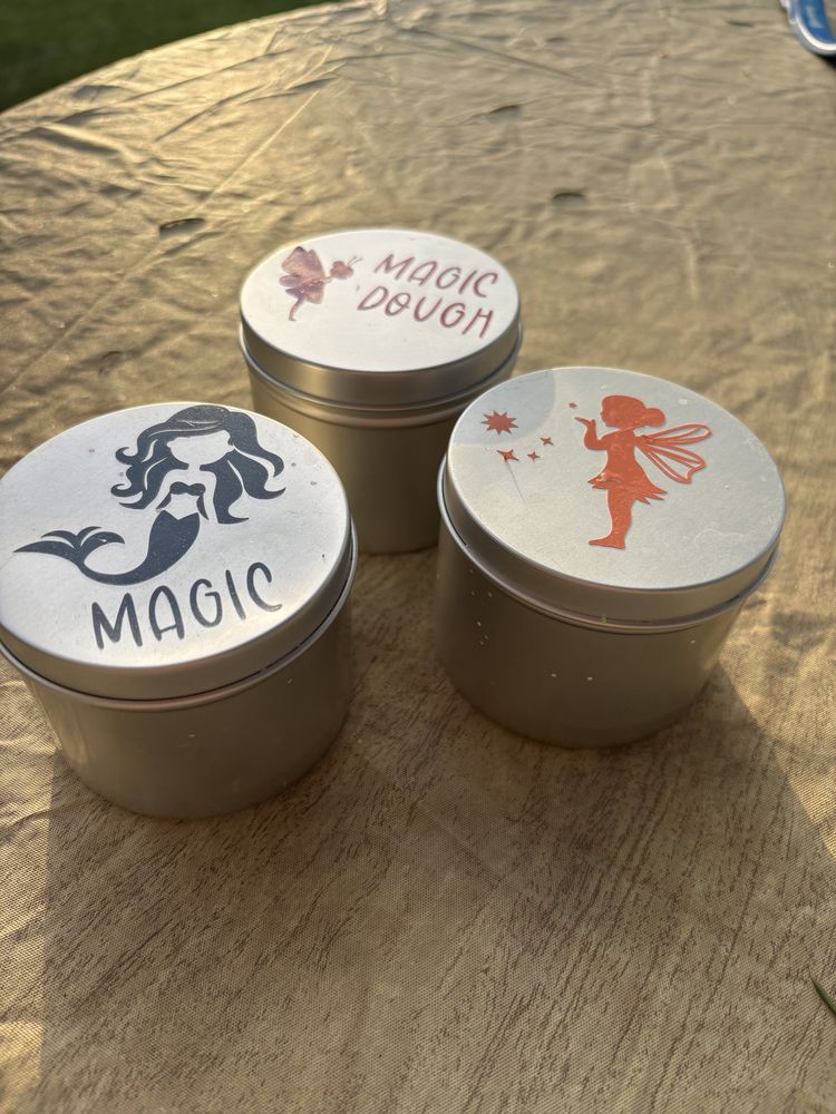 Three round tins of Magic Dough with mermaid and fairy label designs
